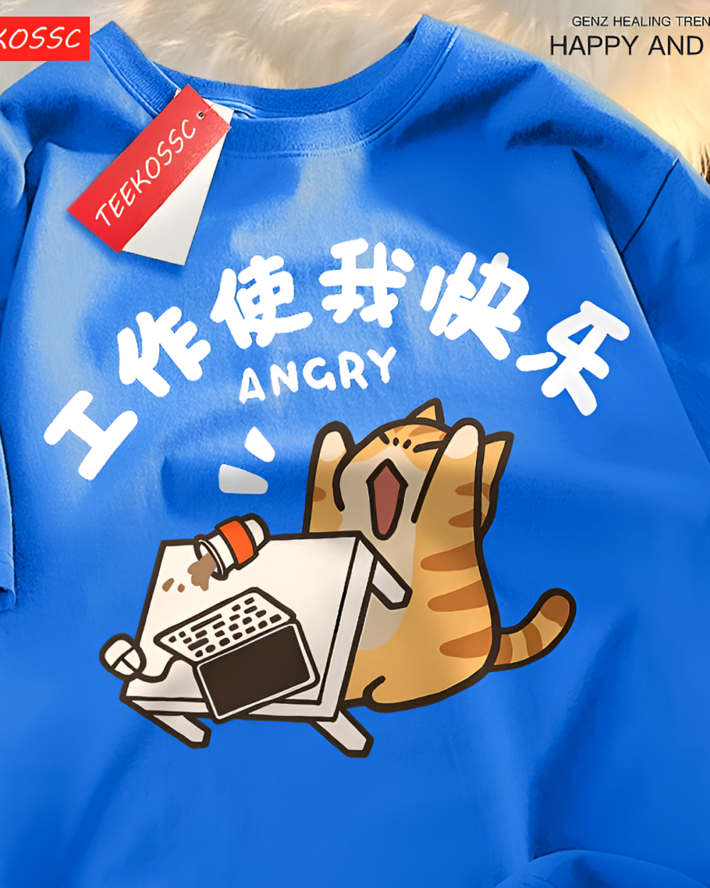 Close-up of a blue Rage Kitty graphic tee with an angry cat working on a laptop. New with tag.