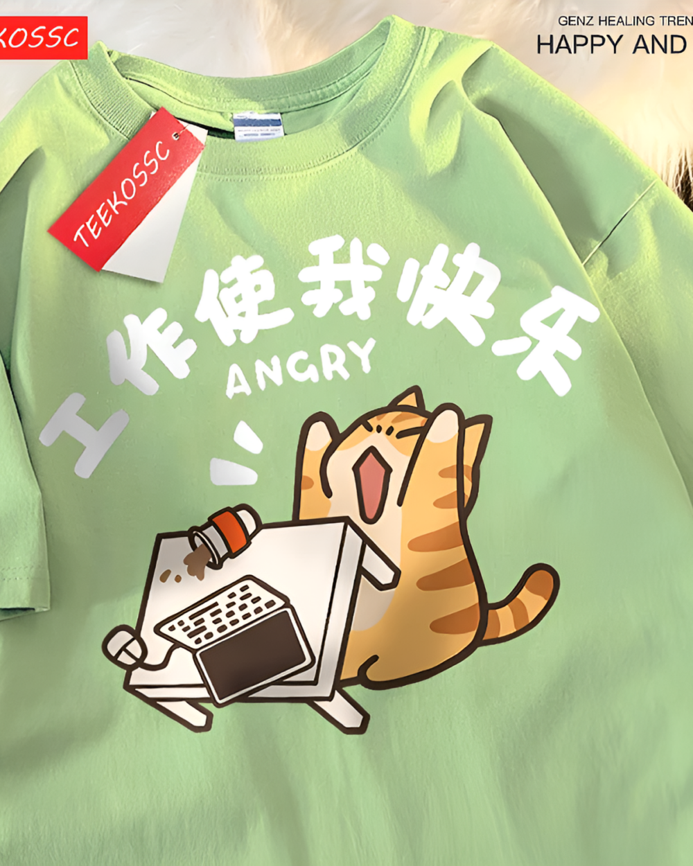 Light green tee with a rage kitty graphic tee design featuring an angry cat working on a laptop. Includes a tag.