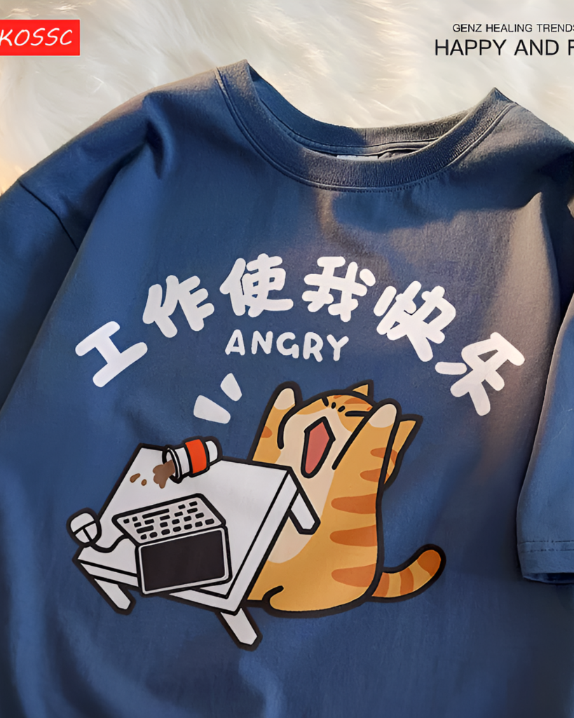 Close-up of a blue Rage Kitty graphic tee with an illustrated angry cat working at a computer.