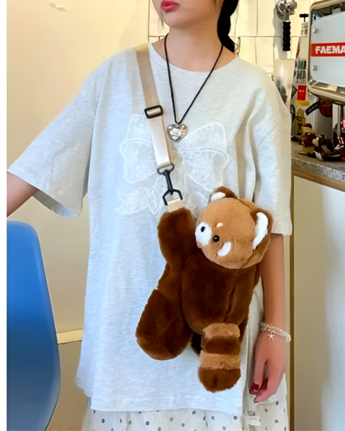 Brown plush Red Panda Plush Backpack worn as a crossbody bag.