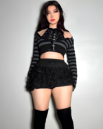 Model wearing black ruffled bloomers and striped top, embodying the mall goth aesthetic style.