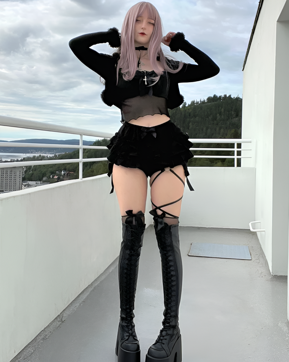 Model wearing ruffled dark bloomers and black outfit, showcasing a mall goth aesthetic. Includes thigh-high boots and choker.