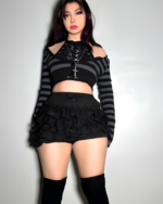 Woman modeling Ruffled Dark Bloomers & striped top, showcasing a mall goth aesthetic fashion style.