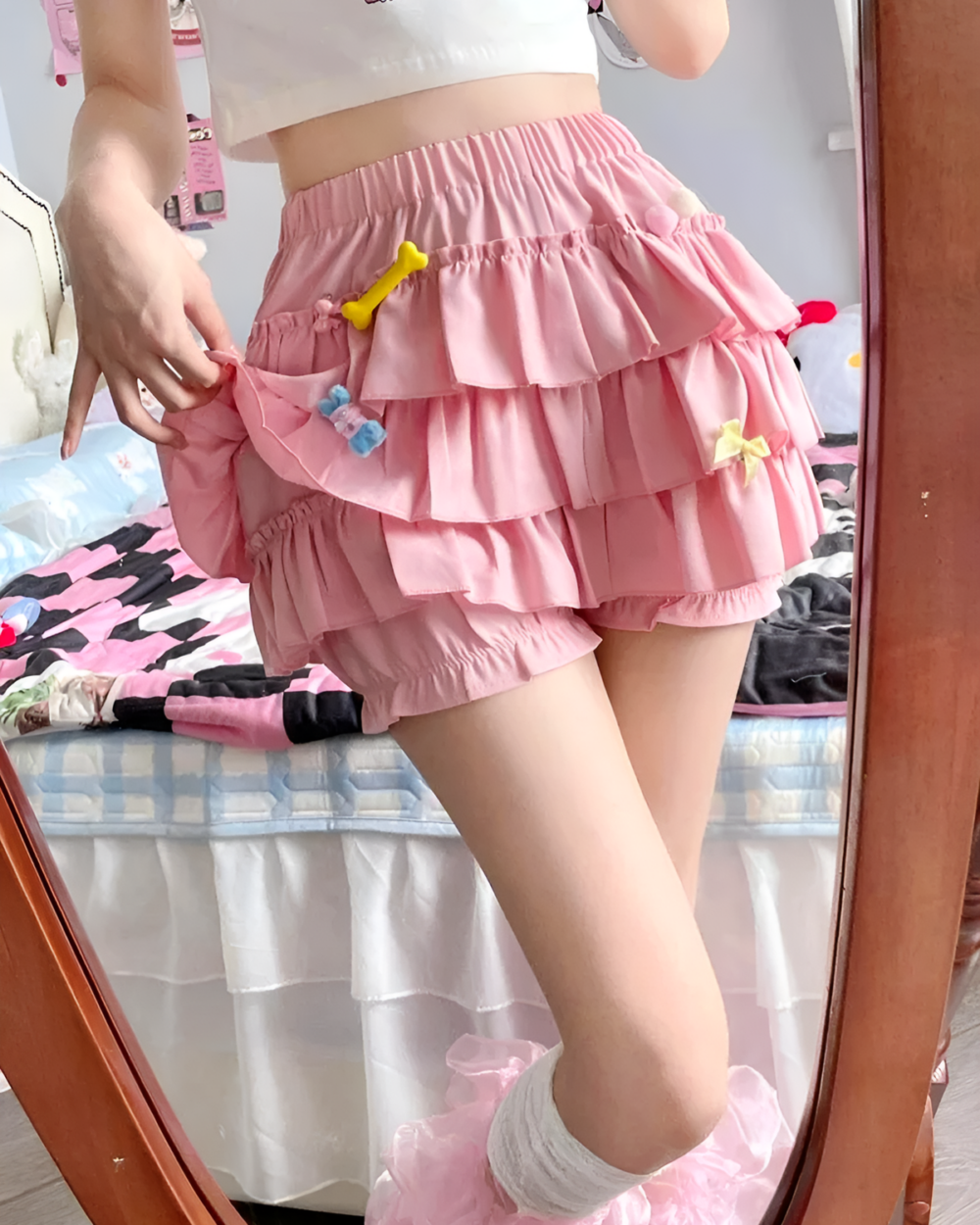 Pink ruffled mini skirt with layered ruffles and a high waist.