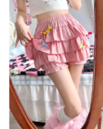 Pink ruffled mini skirt with layers and ruffles, featuring a playful design.