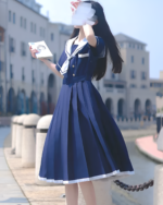 A blue sailor uniform dress (seifuku) worn by a young woman outdoors.