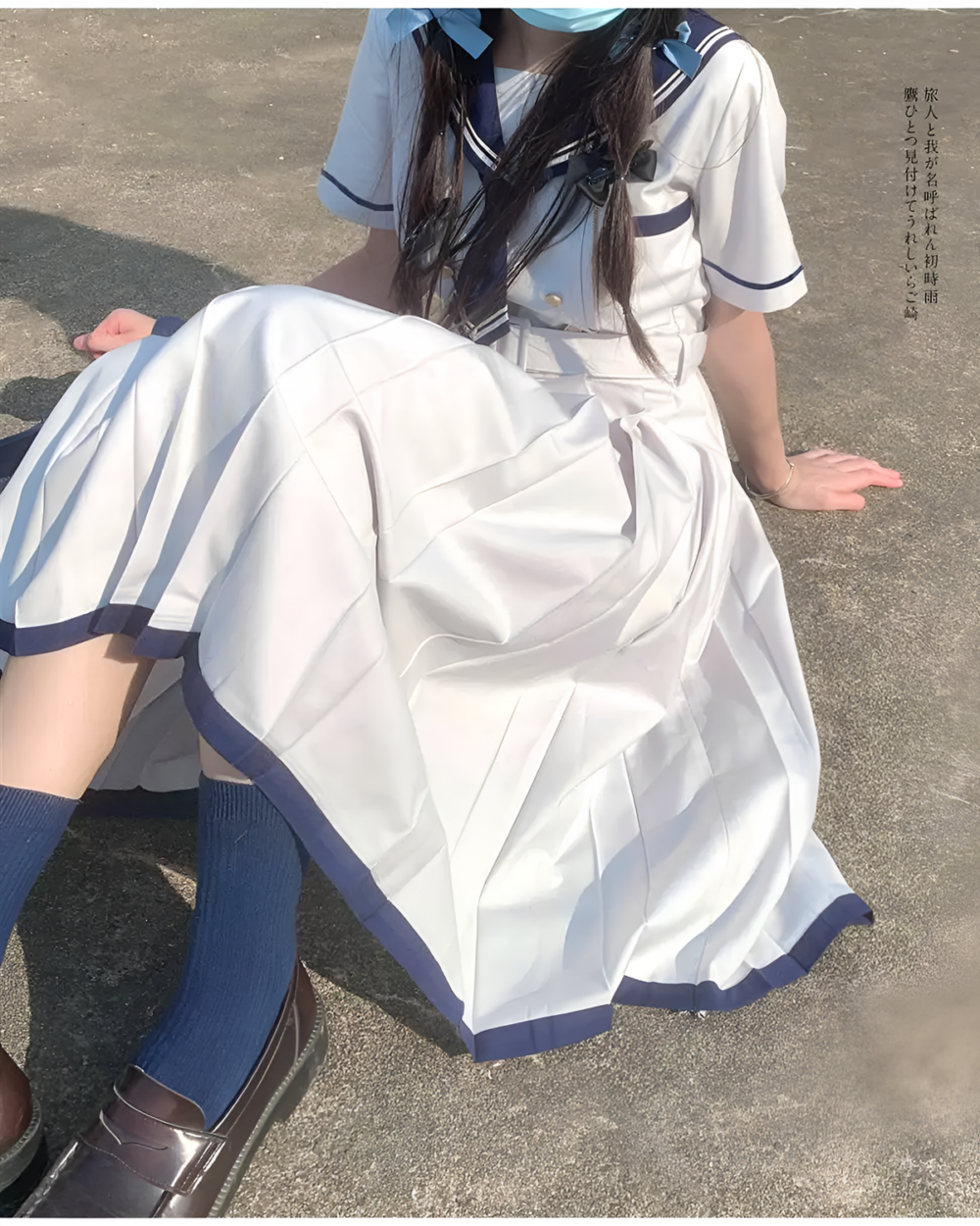 A white and blue sailor uniform dress (Nanchatte Seifuku) with a pleated skirt and socks.