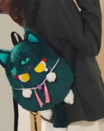 Person wearing a teal ScaraMeow & XiaoMeow backpack, a cute kawaii plush backpack shaped like a cat's head with dangling accessories.