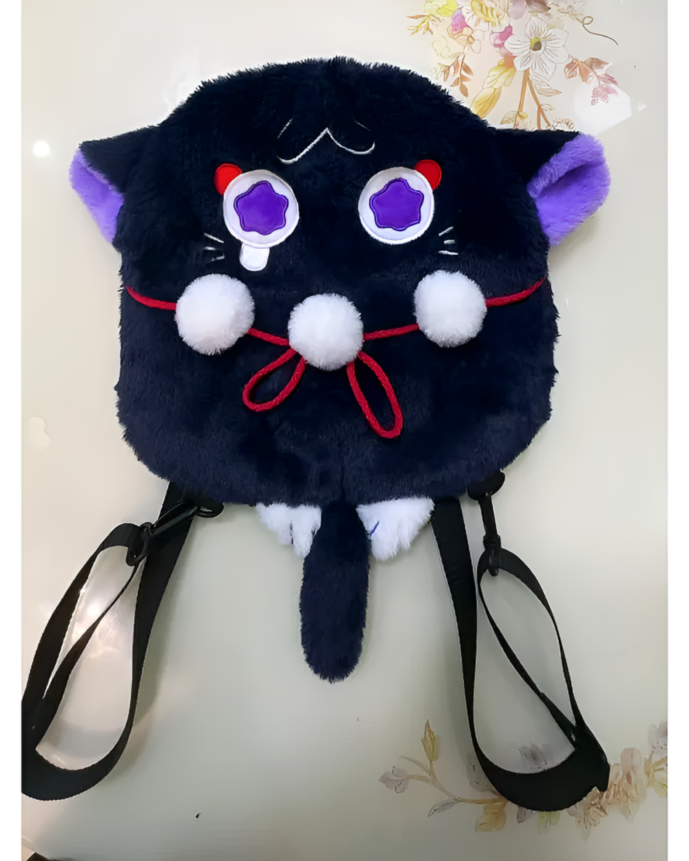 Black ScaraMeow & XiaoMeow plush backpack with purple eyes and white pom-poms. A cute kawaii plush backpack design.