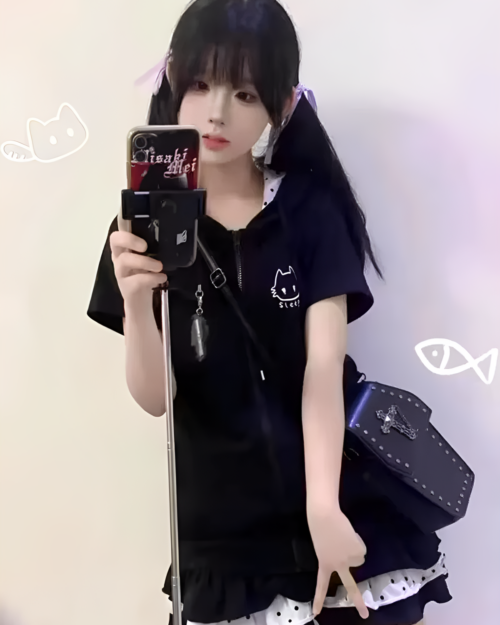 Person wearing a black Sleepy Neko short sleeved hooded t-shirt. Includes a cat graphic and zip-up design.