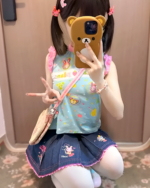 Girl wearing a blue Sleeveless Mezzo Piano top with strawberry and bear graphics. A cute Mezzo Piano top for a stylish look.