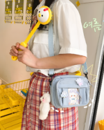 Woman wearing a Small Ita Bag - Colorful Edition with a cute design, showcasing the popular ita bag aesthetic. Includes charms & strap.