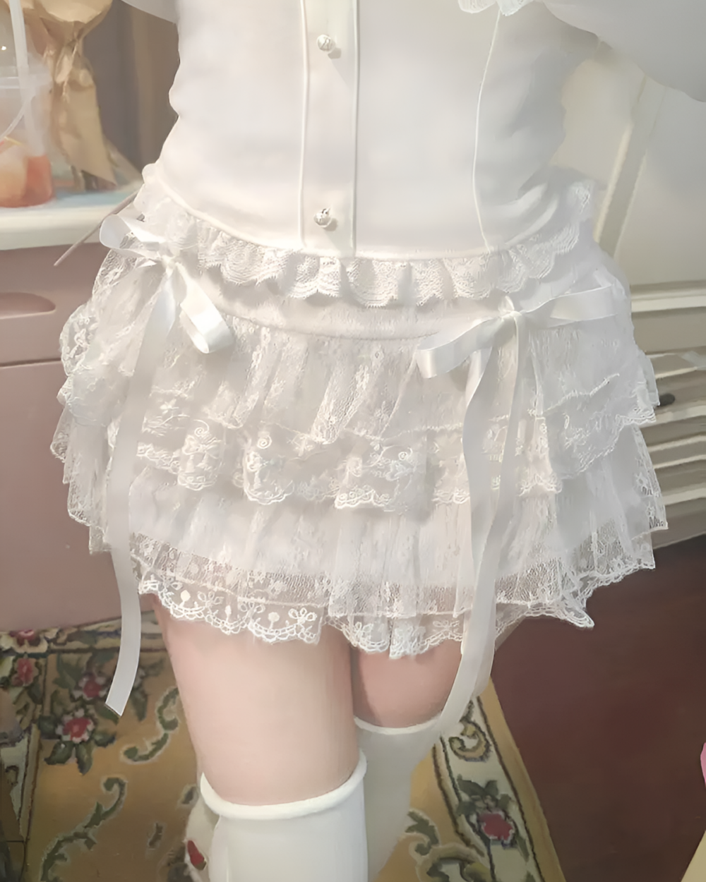 White soft girl aesthetic lace skirt with ribbons and lace trim, featuring a layered tulle effect.