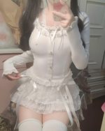 White soft girl aesthetic laced skirt worn with long sleeve top and thigh-high socks.