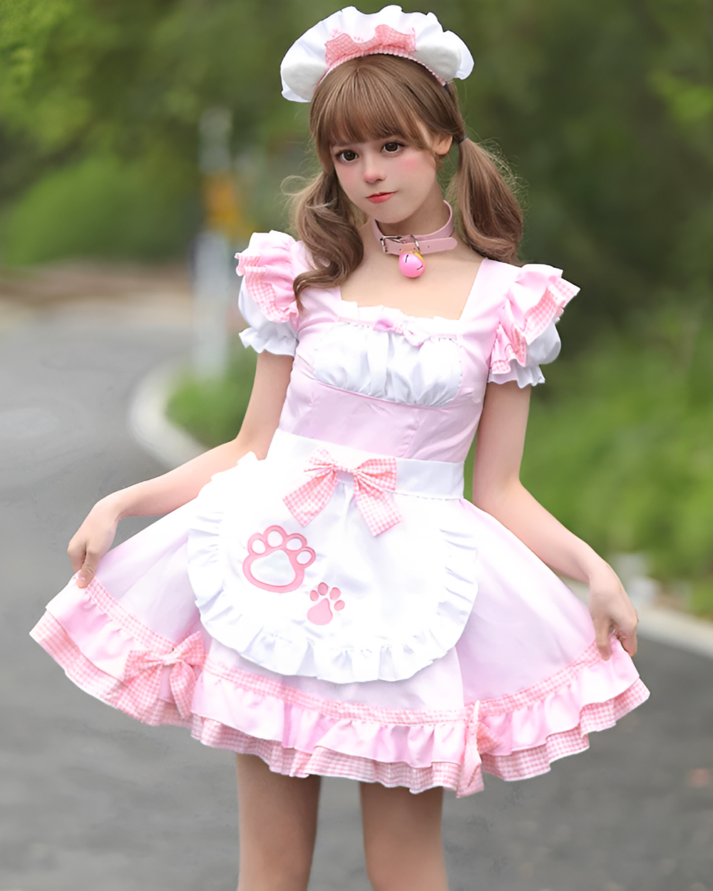 A girl wearing a Soft Girl Maid Dress - Paw Prints Edition, featuring a pink dress, apron, and matching hat.