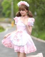 Young woman wearing a pink Soft Girl Maid Dress - Paw Prints Edition, complete with headband and choker.