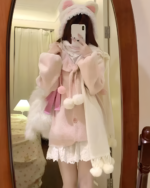 Person wearing a soft girl sweater, fluffy hat, and layered pink accessories against a mirror background.
