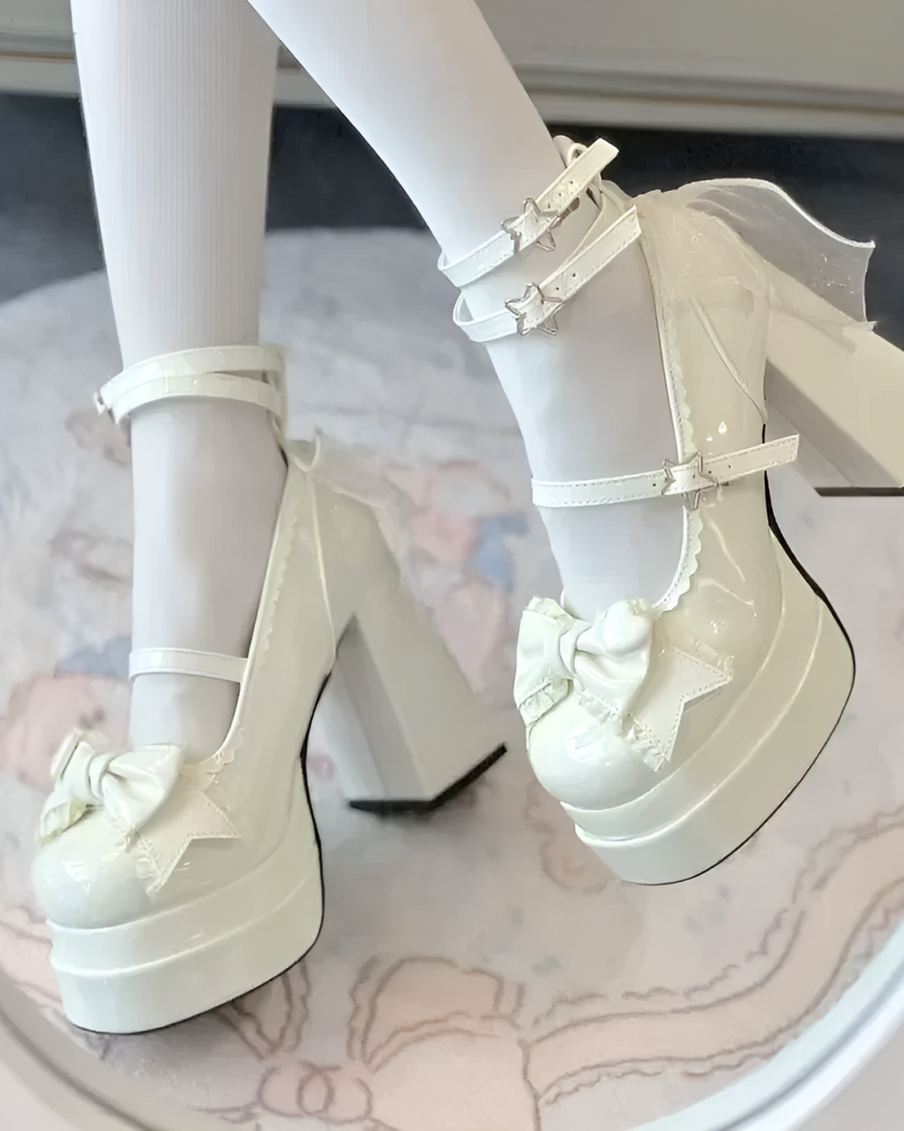 White platform heels featuring a delicate lace-bow detail. These are the Starlit Lace-Bow Mary Janes with a star applique.
