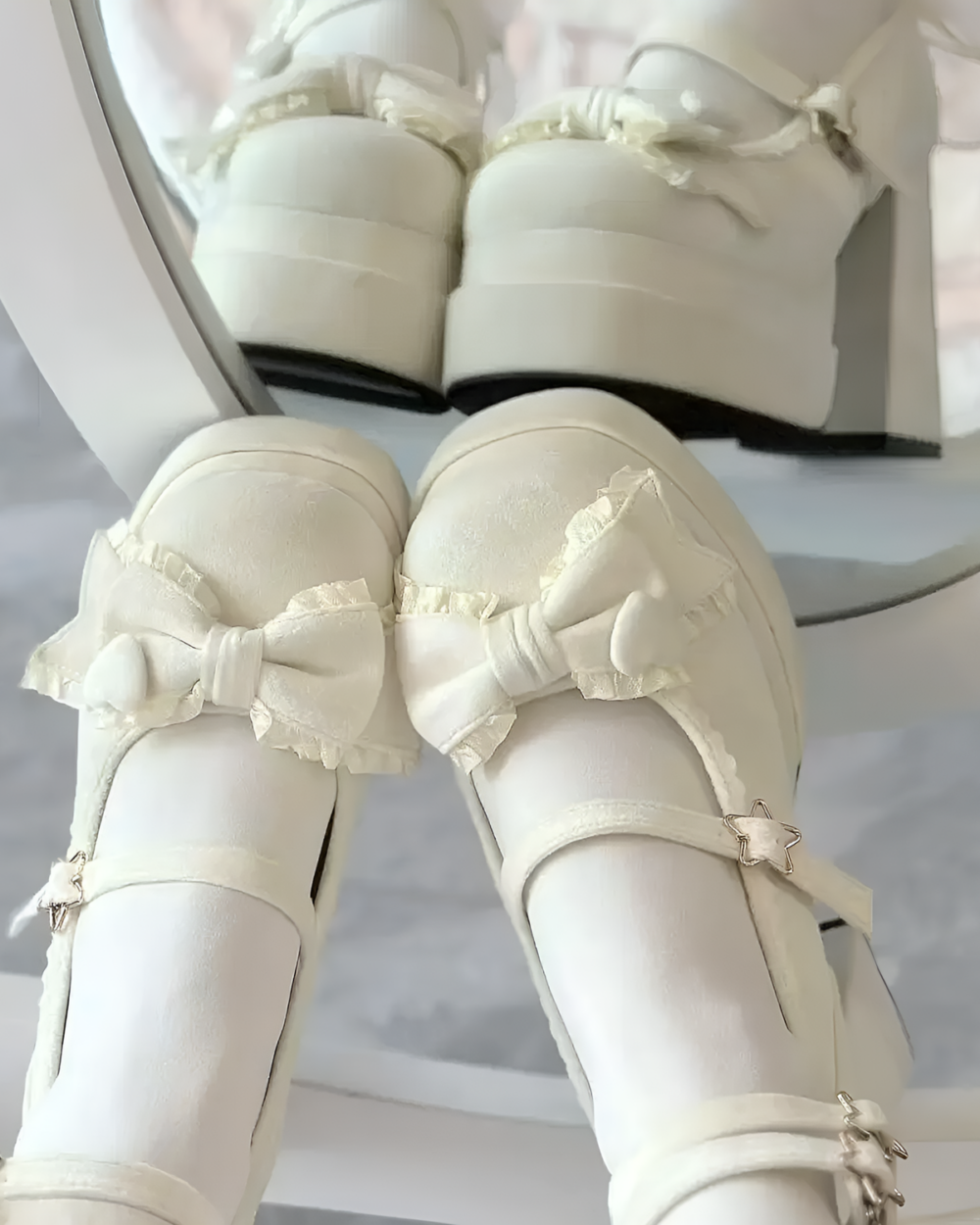 Close-up of white Starlit Lace-Bow Mary Janes with a decorative bow and ankle strap. Platform sole is visible.
