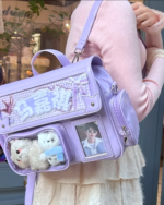 Purple ita bag with clear pockets displaying photos and charms. Korean Edition design with adjustable straps.
