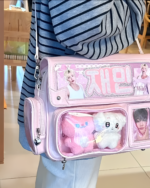 Pink Korean edition ita bag with clear pockets displaying K-pop photos and accessories.