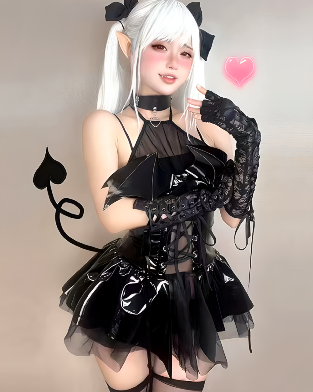 Model wearing a Succubus Bat-Wing Corset Set with bat wings, lace gloves and a mini skirt. Black and white gothic lolita costume.