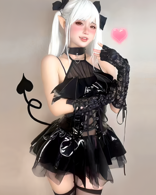 Model wearing a Succubus Bat-Wing Corset Set with bat wings, lace gloves and a mini skirt. Black and white gothic lolita costume.