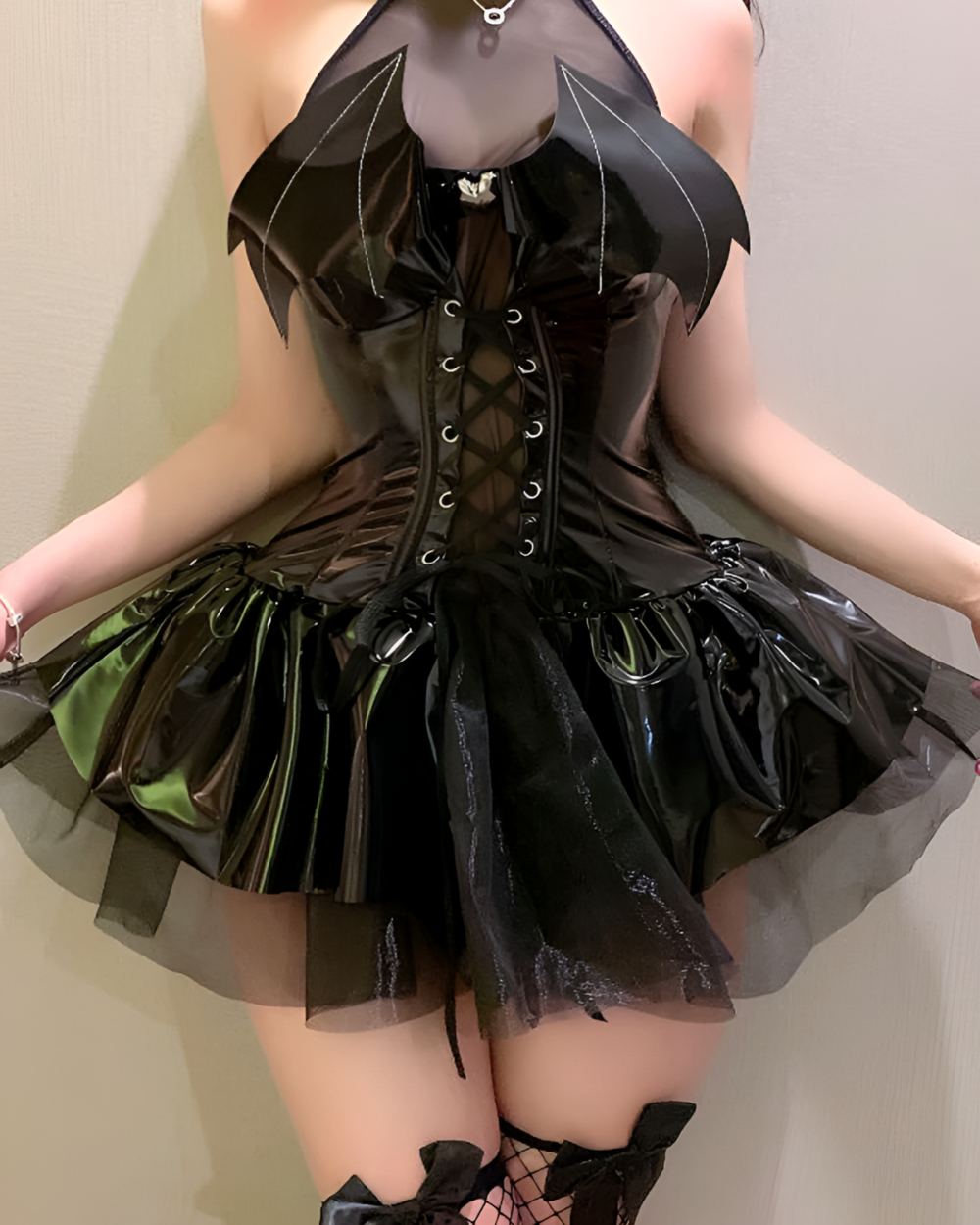 Model wearing the Succubus Bat-Wing Corset Set, a black corset dress with bat-wing details and a tiered skirt. Includes matching gloves.