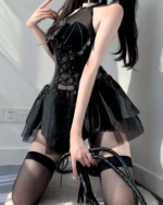 Model showcasing the Succubus Bat-Wing Corset Set, a black outfit with a corset, skirt, and thigh-high stockings.