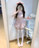Model wearing the Sugarcloud Ruffle-Zip Coord, a pastel pink outfit showcasing a dreamy Yume Kawaii Coord aesthetic with ruffles and a zip-up design.