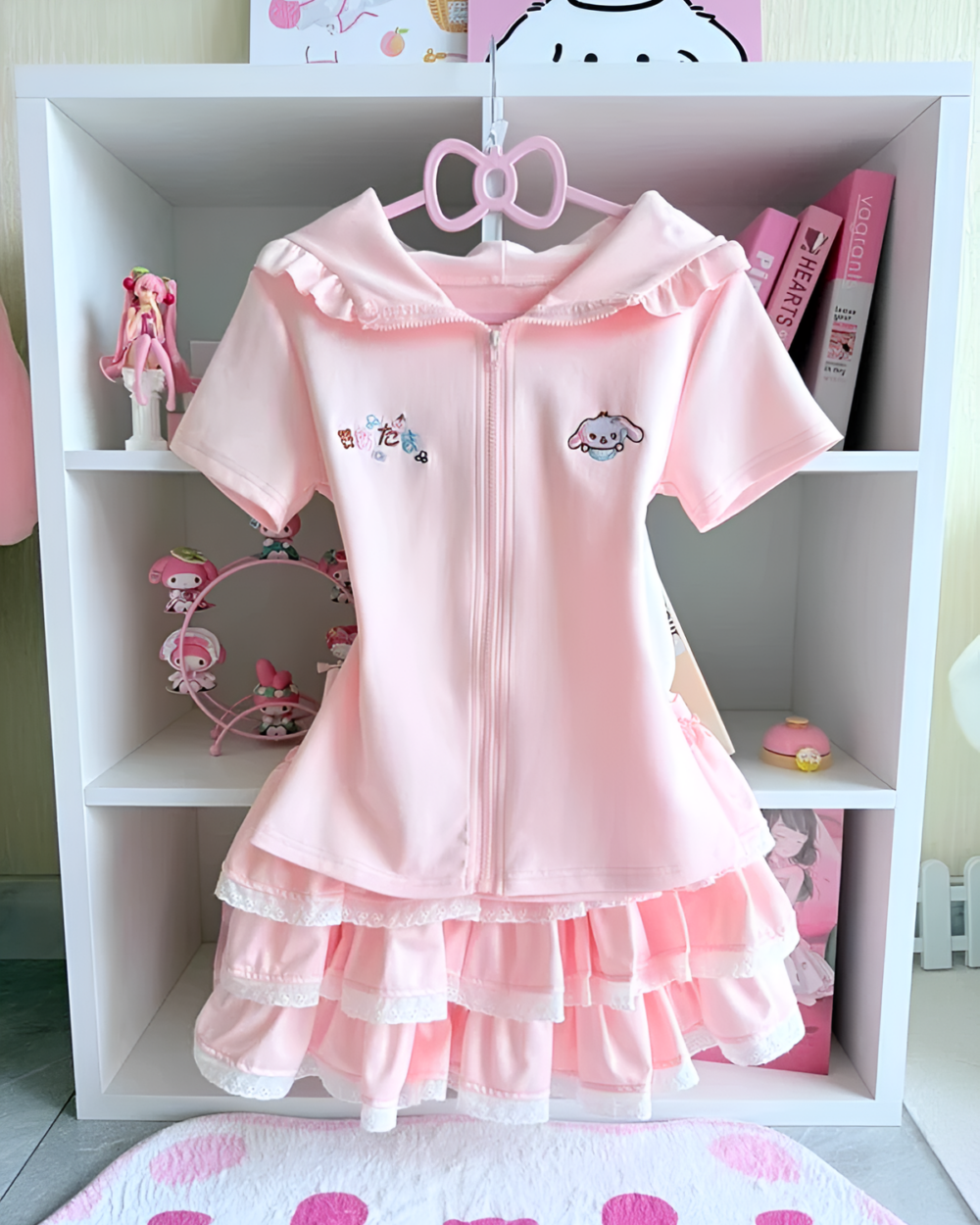 Pink Sugarcloud Ruffle-Zip Coord displayed on a shelf. This Yume Kawaii Coord features a ruffled design and a front zipper.