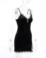 Black goth mini dress with lace trim and cross detail on a transparent mannequin. Spaghetti straps and a fitted silhouette.