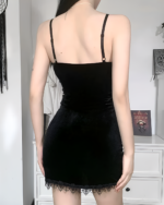 Back view of a black velvet goth mini dress with lace trim. Sleeveless, spaghetti strap design.