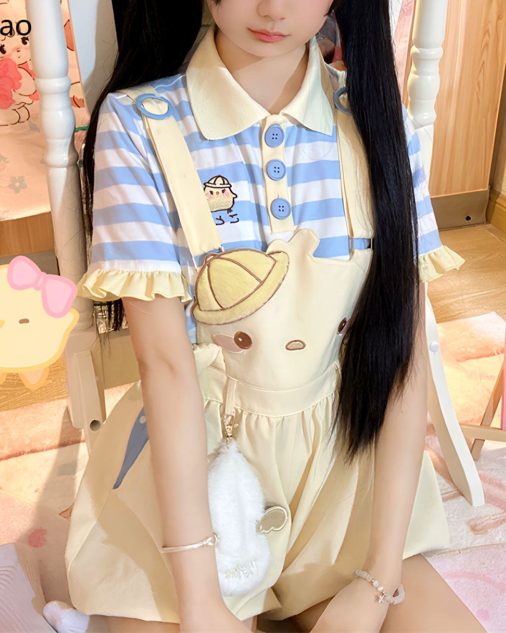 Model wearing a Sunbeam Mascot yellow suspender outfit with a striped blue and white top. A cute and playful look.