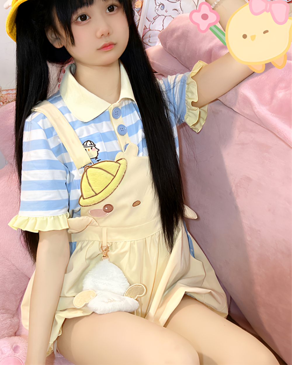 Model wearing a cute Sunbeam Mascot yellow suspender outfit with a striped blue and white top. A modern and playful look.