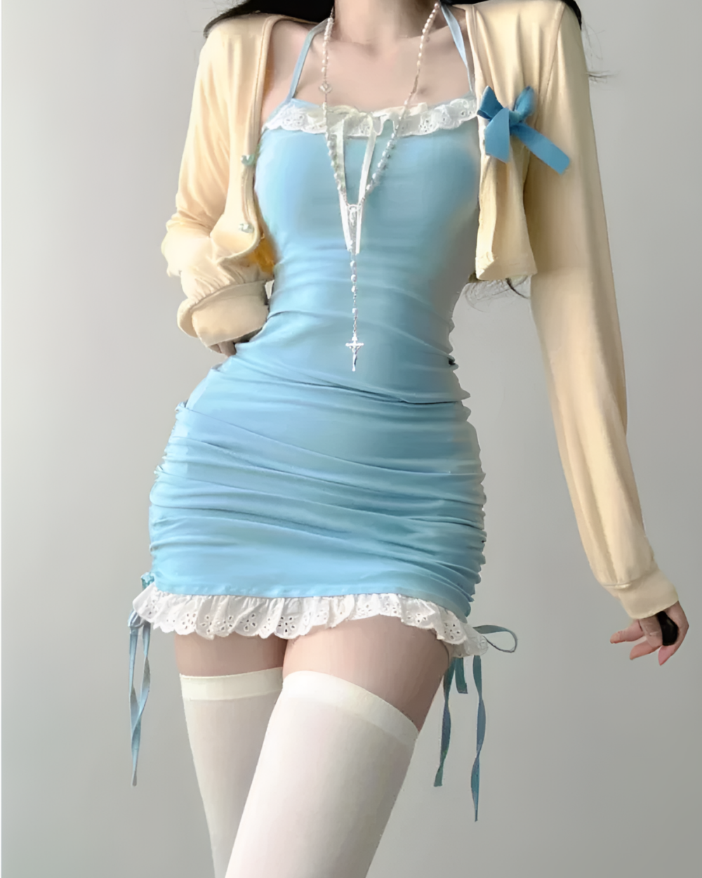Blue Dollette mini dress with long sleeves, lace trim, and matching cardigan.