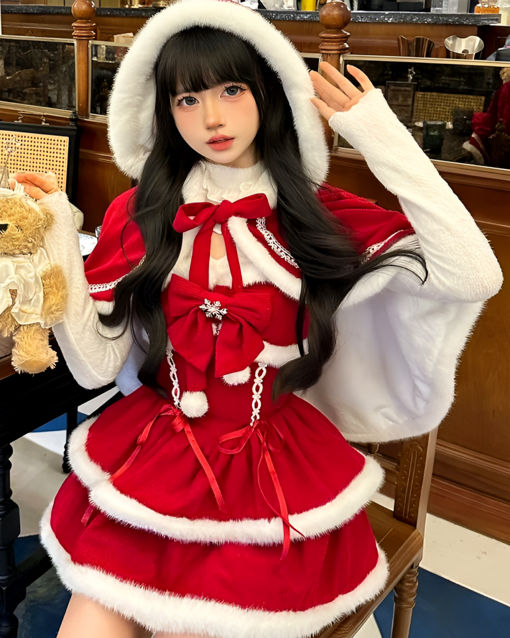 Model wearing a red Sweet Lolita dress with white fur trim and a hood. Perfect for winter events.