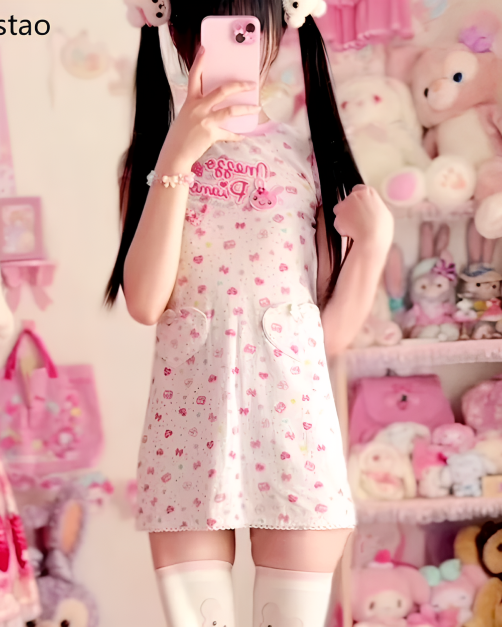 Woman wearing a Sweet Lolita top with a pink and white dotted pattern, featuring a graphic print.