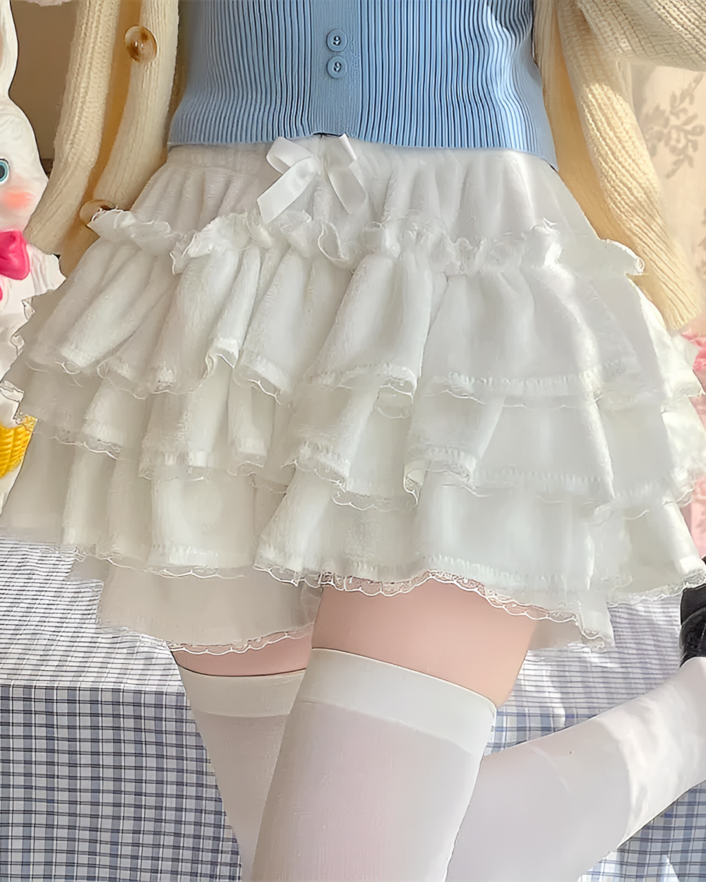 White ruffled Sweet Lolita Plush Skirt layered over a blue skirt.