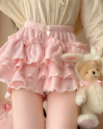 Pink Sweet Lolita Plush Skirt with ruffles and bow, next to a plush bunny.
