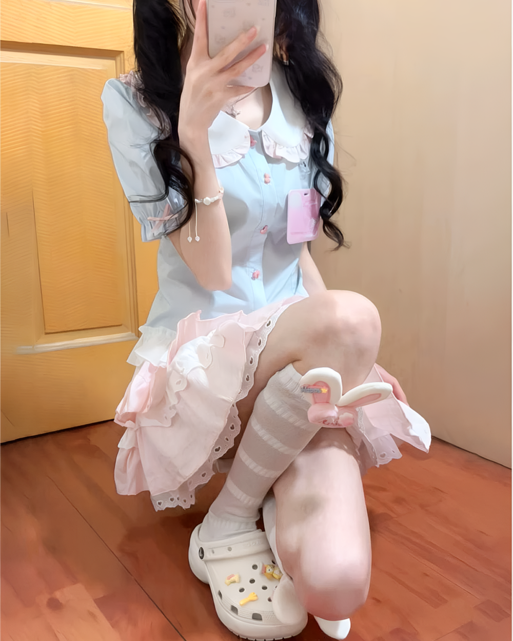 Model wearing a blue Sweet Lolita School Suit with pink frills and socks.