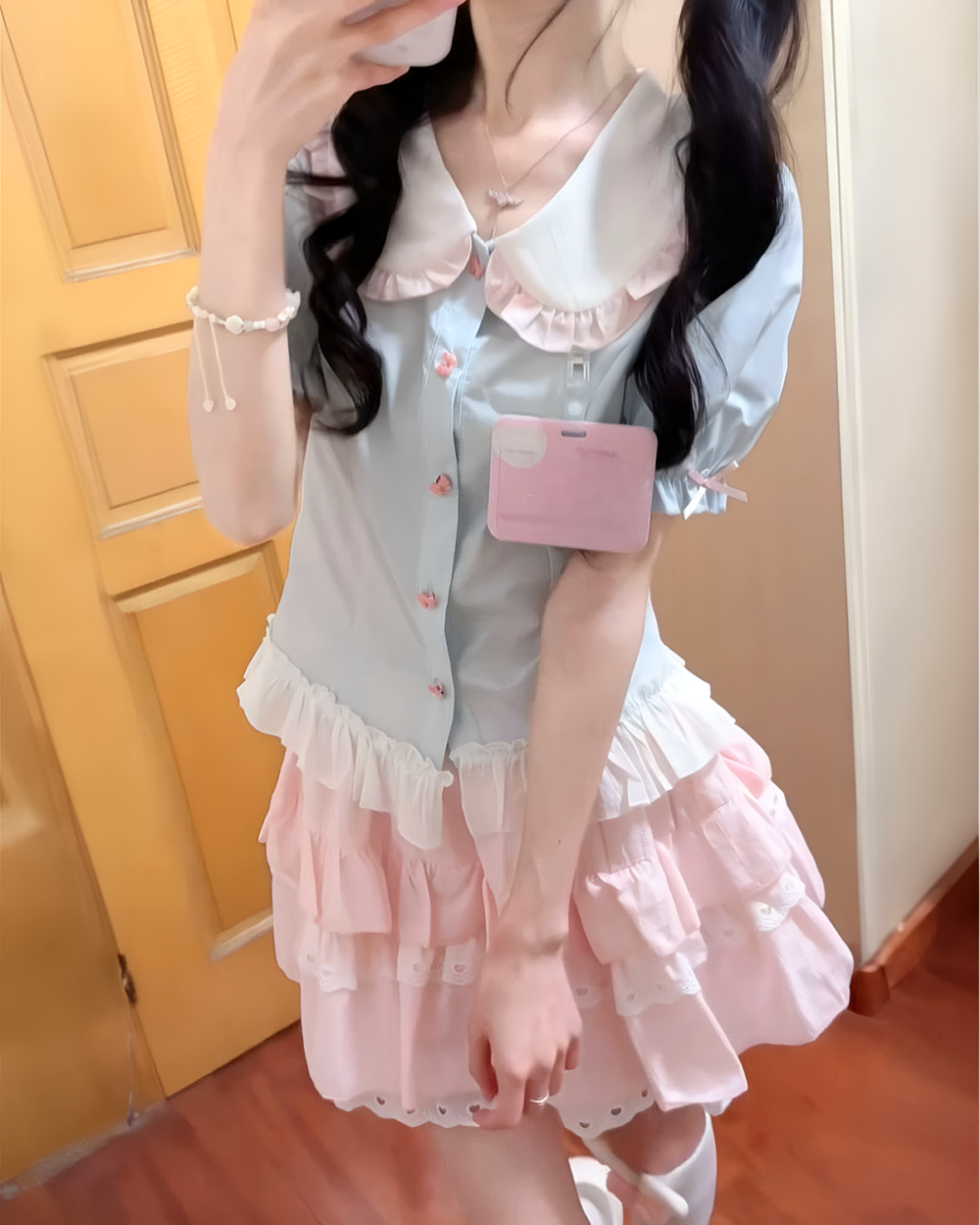 Model wearing a blue Sweet Lolita School Suit with a pink skirt and lace details.