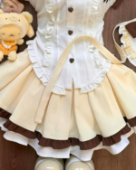 Close-up of a Sweet Lolita set - Pudding Edition, featuring a cream blouse and layered brown skirt with ruffles.