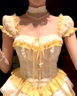 Close-up of a yellow Sweet Lolita dress with puff sleeves and lace detailing.