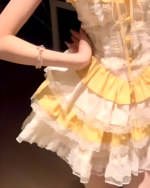 Close-up of a yellow Sweet Lolita dress with ruffles and lace details.