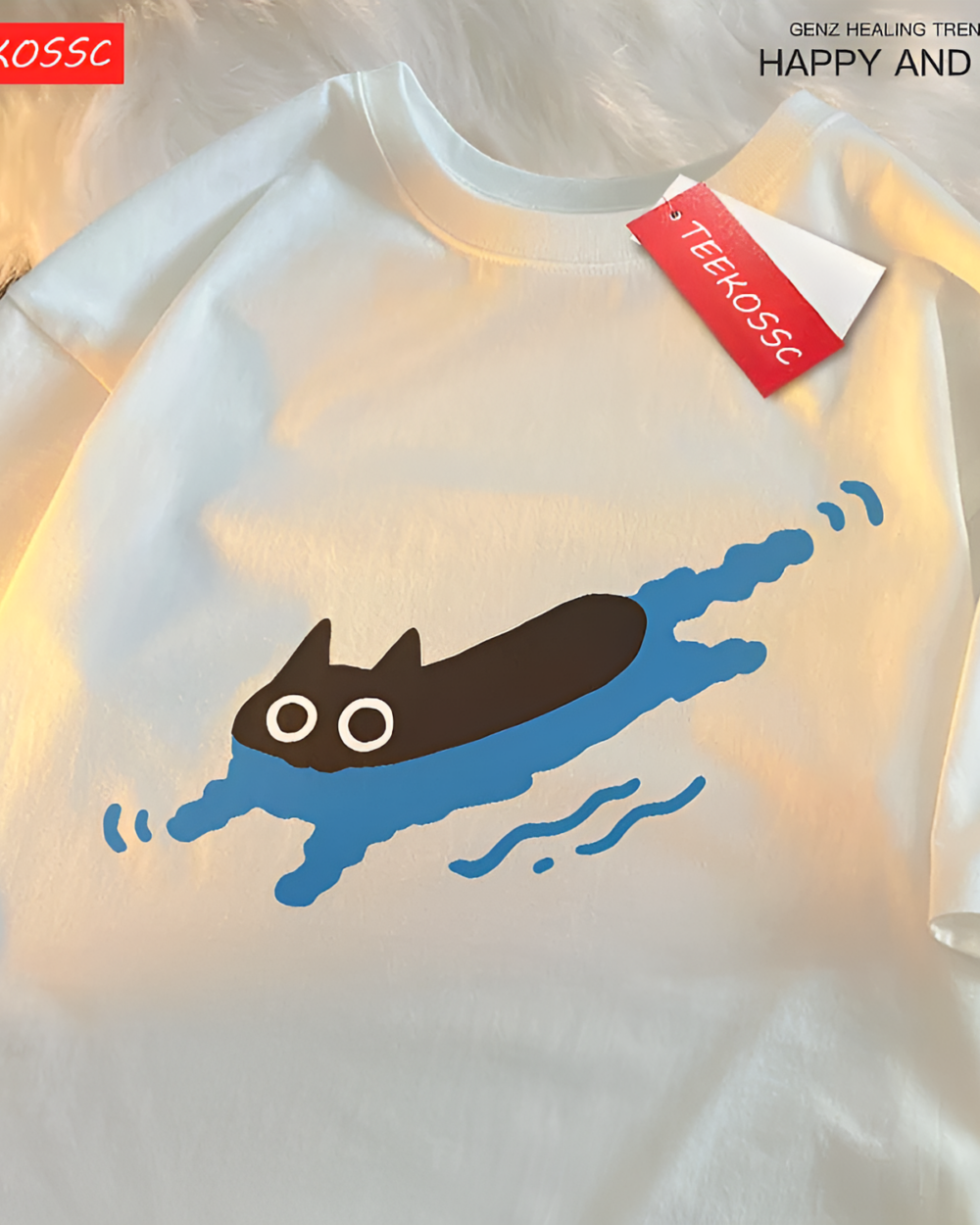 White t-shirt featuring a graphic of a black cat swimming in blue water. This is the Kuro Neko T-Shirt, designed with a playful illustration.