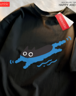 Black Kuro Neko T-Shirt featuring a blue cat swimming illustration. Tag attached. Casual wear.