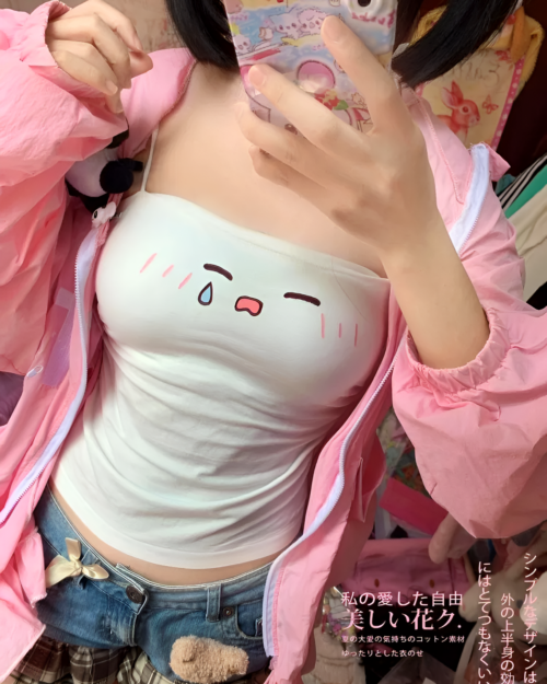 Close-up of a white camisole featuring a sad chibi kaomoji face. The product is a Tearful Chibi Kaomoji Camisole.