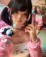 Person wearing a white Tearful Chibi Kaomoji Camisole with lace trim, posing indoors with plush toys.