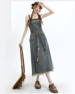 Woman wearing The Autumn Set, a denim dress with a belt and bag.